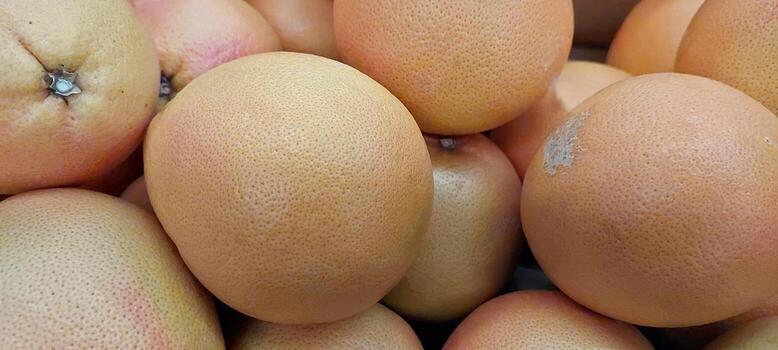 Fresh Citrus Fruits Displayed in a Grocery Store During Midday Shopping Rush photo