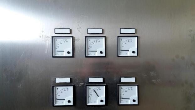 Cabinet Panel Displaying Multiple Ammeters for Electrical Current Measurement photo