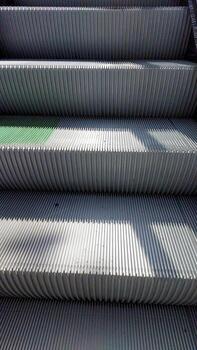 Escalator Stairs Leading Upwards in a Busy Urban Environment During Daylight Hours photo