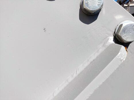 Close-up of Metallic Flange With Bolts and Nuts in Industrial Setting During Daylight Hours photo