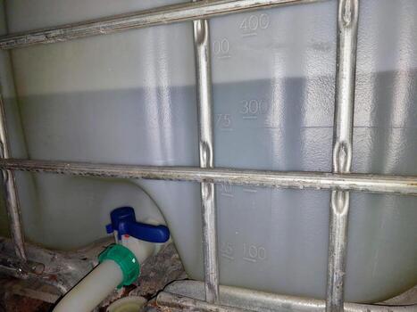 Industrial Liquid Container Displayed Prominently in a Warehouse Setting During Daylight Hours photo