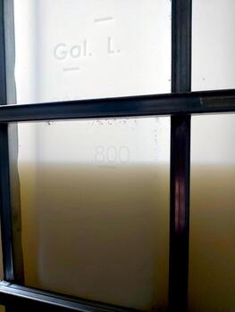 Industrial Container Filled With Liquid Located in a Storage Area During Daylight Hours photo