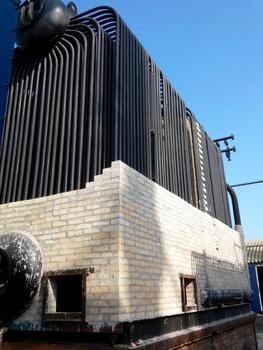 Installation of a Steam Boiler in an Industrial Setting During Daytime photo