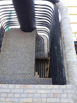 Installation of a Steam Boiler at a Construction Site Featuring Complex Piping and Brickwork photo