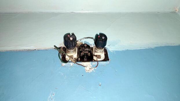 Old Electrical Fuses Mounted on a Blue Wall in a Vintage Setting photo