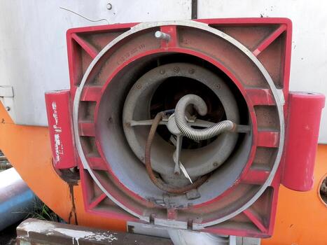 Old Steam Boiler Equipped With a Component of a Gas Burner in an Industrial Setting photo
