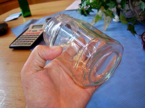 Holding a Square Glass Jar While Working at a Cozy Home Desk During a Productive Afternoon photo