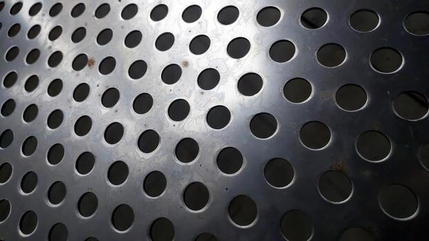 A close up of a metal perforated surface photo