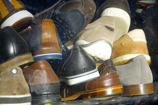 Various Footwear Displayed in Storefront Window Showcasing Diverse Styles and Colors photo