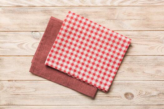 top view with red empty kitchen napkin isolated on table background. Folded cloth for mockup , Minimal style photo