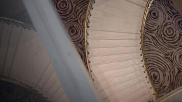 elegant spiral staircase, from above view of marble staircase with intricate patterns and warm video