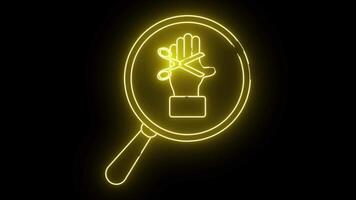 Illuminated yellow neon A magnifying glass enframes a hand with scissors across it all on a stark black backdrop video