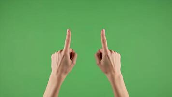 Two hands pointing upwards against a vibrant green background, symbolizing guidance, direction, and selection Perfect for concepts related to choice, recommendation 4k video