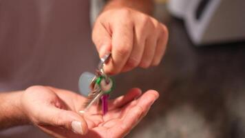 A CloseUp View of Hands Gracefully Dropping Keys into an Open Palm for Easy Access video