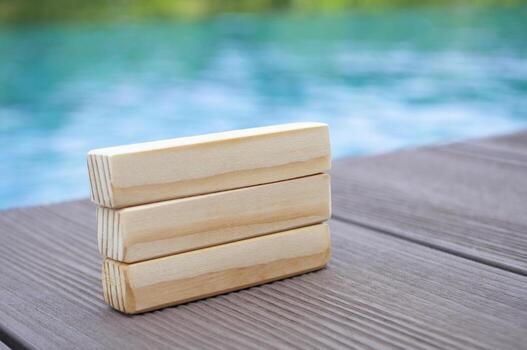 Wooden blocks with pool background, with customizable space for text. photo