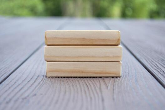 Wooden blocks with customizable space for text and with nature background. photo