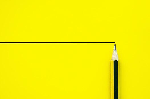 Bright yellow sheet with horizontal rule and sharpened pencil corner with customizable space for text photo