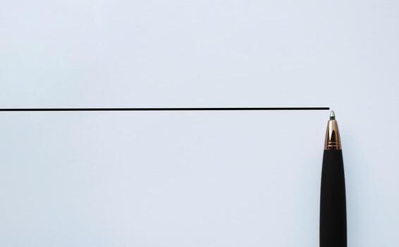 Horizontal ruled paper with a pen tip at the edge, ample copy space for notes and clean minimal planning. photo