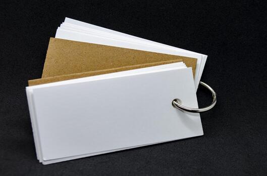 White banner shape notepad with customizable space for text on black cover background. Copy space concept. photo