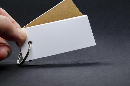 White banner shape notepad with customizable space for text on dark background. photo