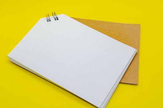 White banner shape notepad with customizable space for text on yellow background. photo