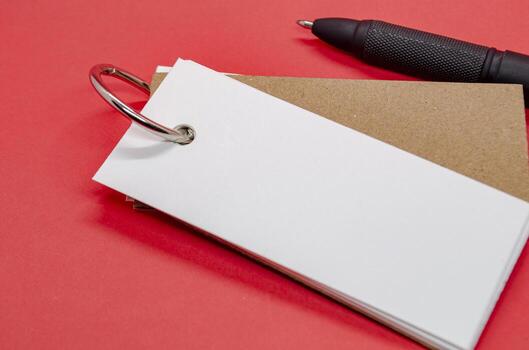 White banner shape notepad with customizable space for text on red background. photo