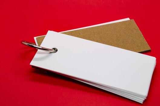 White banner shape notepad with customizable space for text on red cover background. photo
