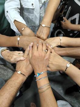 Hands folded together in the center of the frame symbolize unity, friendship and support. photo