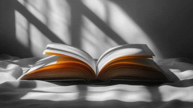 An open book on a bed with sunlight coming through the window photo