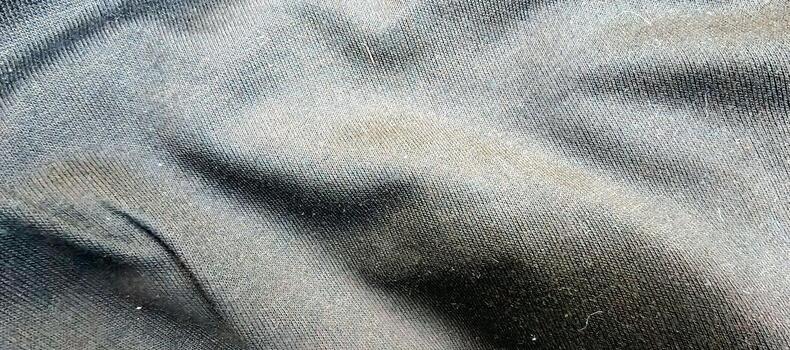Elegant close-up of a light blue fabric texture. The image captures the fine weave and a slightly fuzzy surface, creating a sense of comfort and softness photo