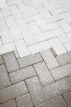 Clean Neutral Paver Block Surface with Herringbone Pattern for Outdoor Flooring photo