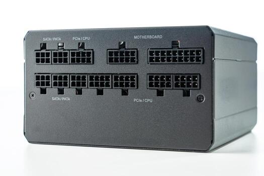 Close-up of a modular power supply unit featuring SATA, PATA, PCI, and CPU connectors. Ideal for showcasing computer hardware components in system builds and upgrades. photo