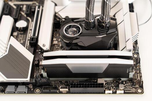 Close-up of a computer motherboard featuring advanced cooling solutions and RAM modules. Perfect for showcasing PC building, gaming setups, and technology concepts. photo