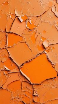 Cracked surface with vibrant orange liquid pooling in the deep fissures of dry, textured material. photo