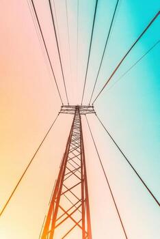 Tower structure with wires against a gradient sky, looking upwards. photo