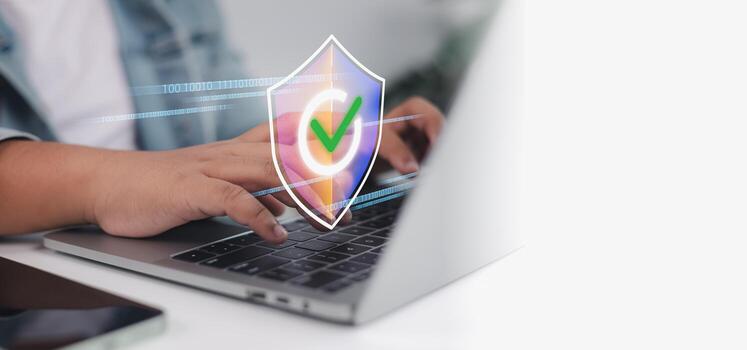Cybersecurity and data protection. user typing on laptop with digital shield and secure network icon photo