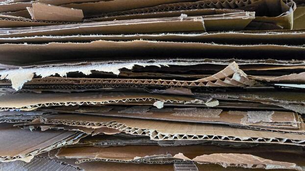 Cardboard crates stacked background. Stacking used cardboard for recycling. Full frame photo, horizontal format. photo