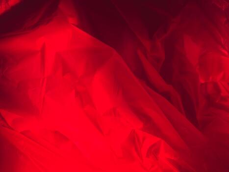 Red glow bouncing off plastic in mysterious backdrop photo
