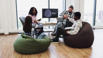 Young co-workers engaging in collaborative work focused on artificial intelligence, sharing ideas, and supporting each other. Highlights teamwork, innovation, and inclusivity in a creative environment video