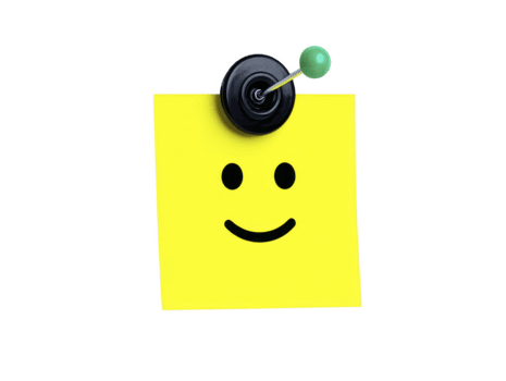 Smiling yellow sticky note with simple face drawing, attached to surface by black round magnet with green pin, isolated on transparency background, cheerful and minimalistic png