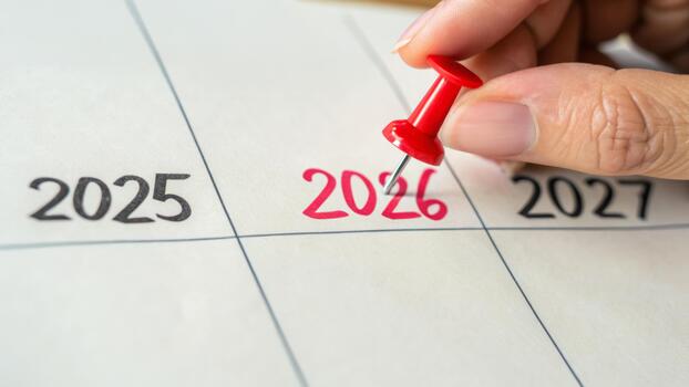 Upcoming new year business goal change marked on calendar with red pin symbolizing planning and ambition photo