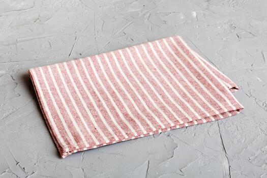 top view with red empty kitchen napkin isolated on table background. Folded cloth for mockup with copy space, Flat lay. Minimal style photo