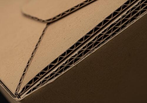 Detailed close up of brown corrugated cardboard box edge showing layers photo