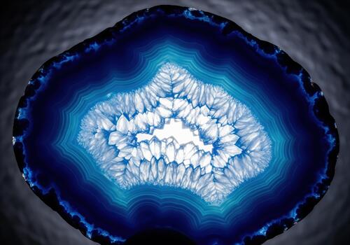 Backlit abstract macro view of vibrant blue agate geode mineral cross section photo
