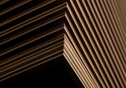 Abstract geometric pattern of stacked dark plywood layers and striped wood texture. photo