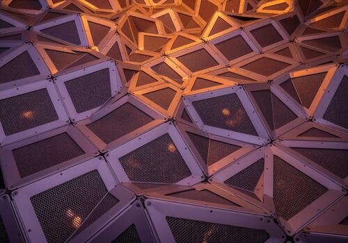 Complex geometric metal mesh panels forming a futuristic architectural surface texture photo