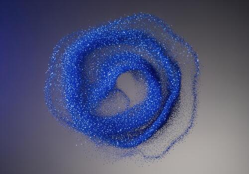 Dynamic spiral of shimmering sapphire blue glitter dust on a gray background photo