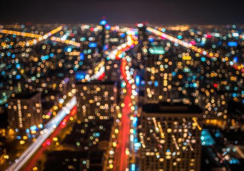 Abstract aerial view of city night lights with bokeh effect and long exposure traffic trails photo
