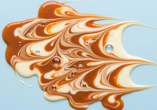 Mesmerizing glossy swirl of vibrant caramel and white cream creating an abstract marble texture photo