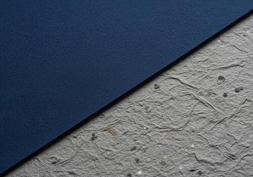 Abstract texture background showing contrast between smooth navy blue material and rough gray paper. photo